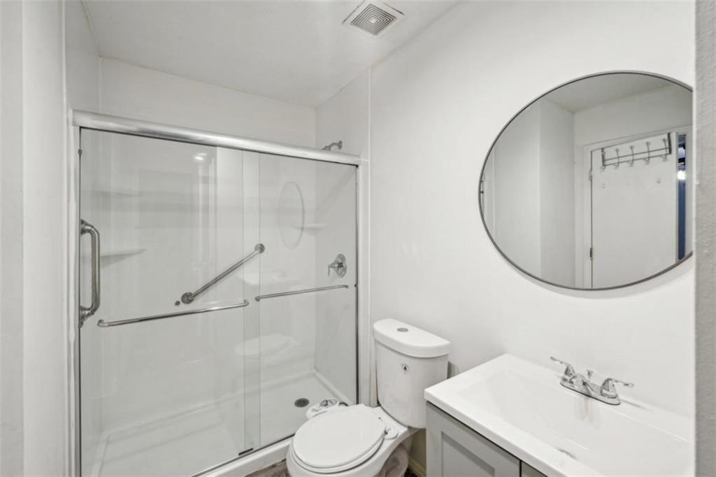 703 Pine Tree Trail Atlanta, GA 30349 - Photo 23 of 32 a bathroom with a sink toilet and shower