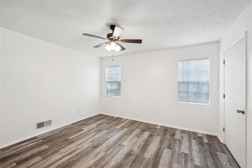 703 Pine Tree Trail Atlanta, GA 30349 - Photo 24 of 32 a view of empty room with wooden floor and fan