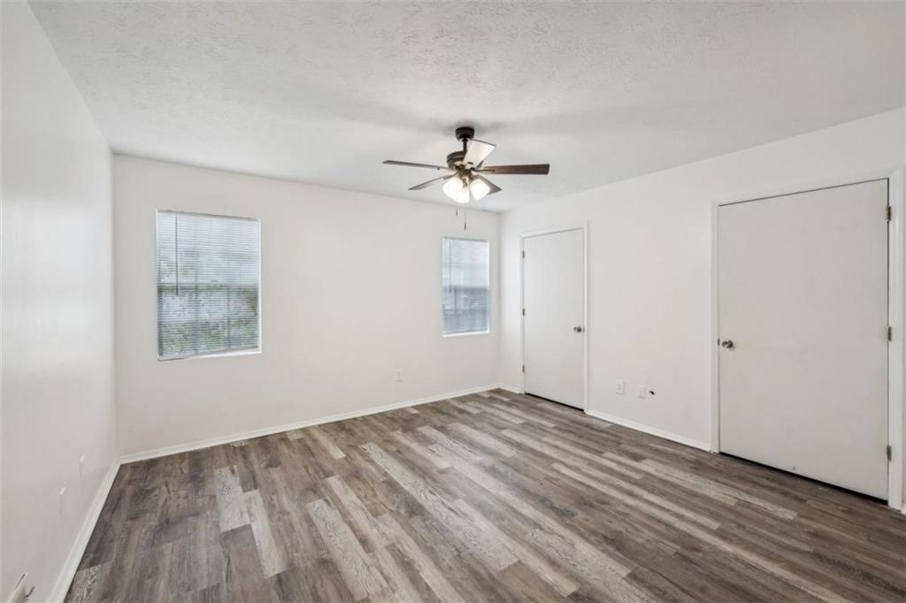 703 Pine Tree Trail Atlanta, GA 30349 - Photo 26 of 32 wooden floor in an empty room with a window