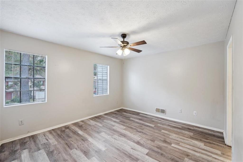 703 Pine Tree Trail Atlanta, GA 30349 - Photo 30 of 32 wooden floor in an empty room with a window