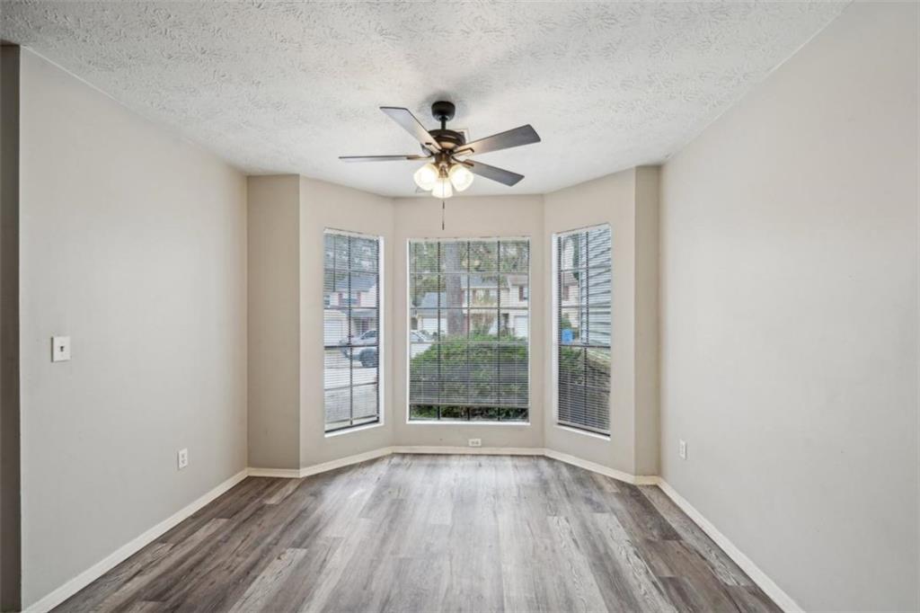 703 Pine Tree Trail Atlanta, GA 30349 - Photo 7 of 32 wooden floor in an empty room with a window
