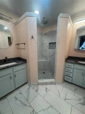 a bathroom with a granite countertop sink a toilet and a mirror