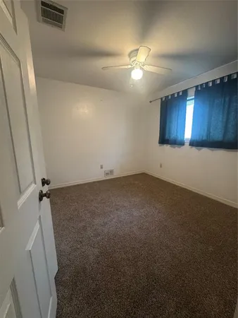 an empty room with a view of a bathroom