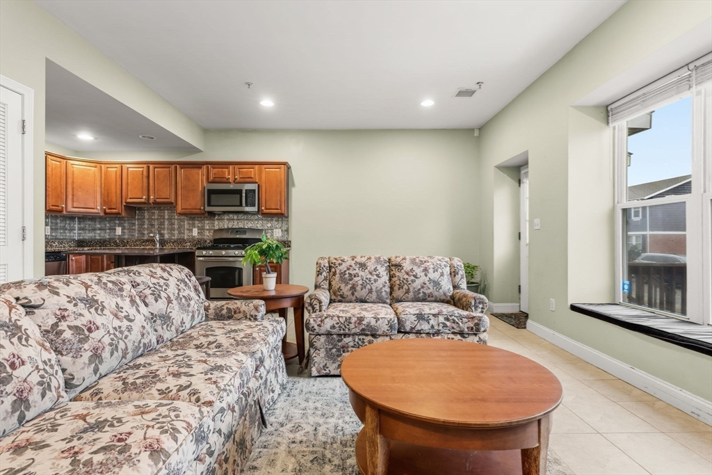 910 Saratoga Street, Unit 5 Boston, MA 02128 - Photo 4 of 24 a living room with furniture and a large window