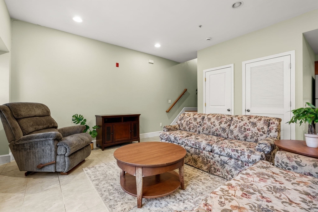 910 Saratoga Street, Unit 5 Boston, MA 02128 - Photo 5 of 24 a living room with furniture and a fireplace