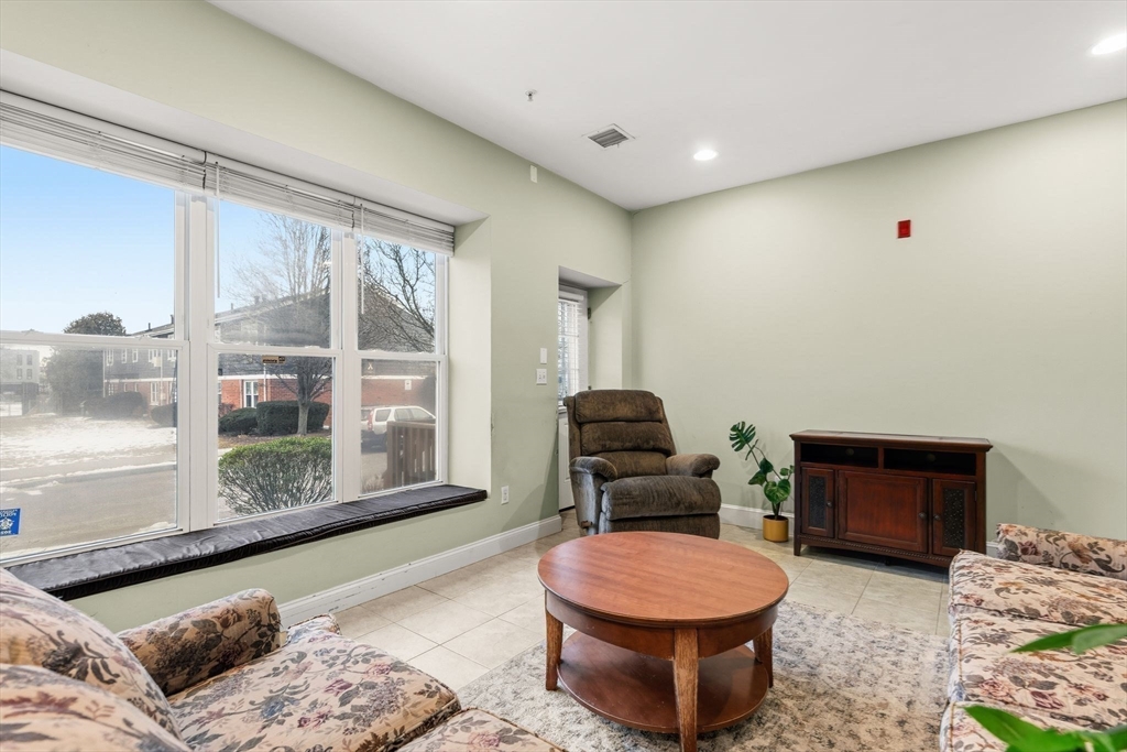 910 Saratoga Street, Unit 5 Boston, MA 02128 - Photo 6 of 24 a living room with furniture and a window