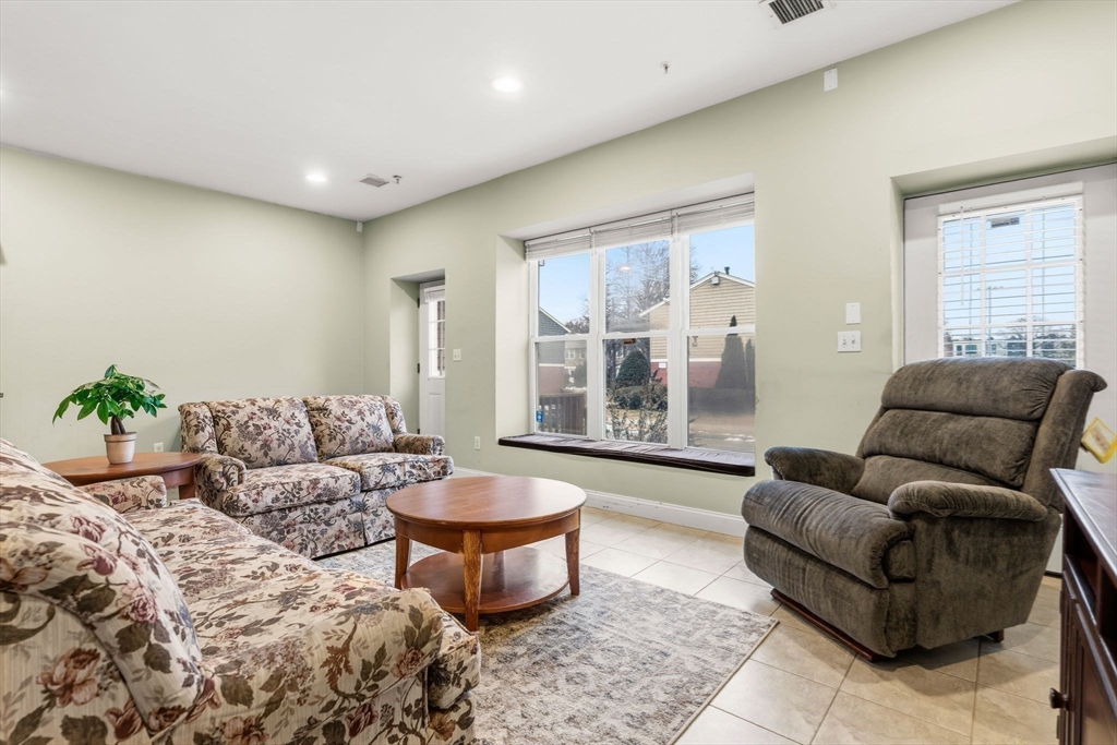 910 Saratoga Street, Unit 5 Boston, MA 02128 - Photo 7 of 24 a living room with furniture and a large window