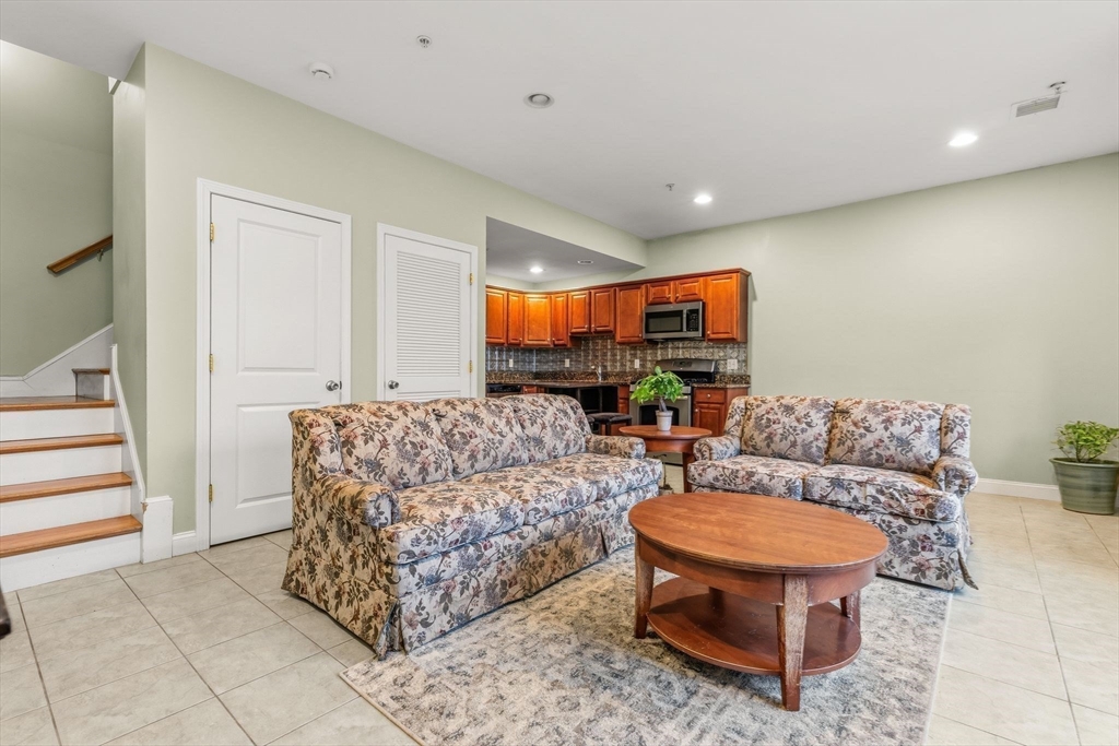 910 Saratoga Street, Unit 5 Boston, MA 02128 - Photo 8 of 24 a living room with furniture and a painting