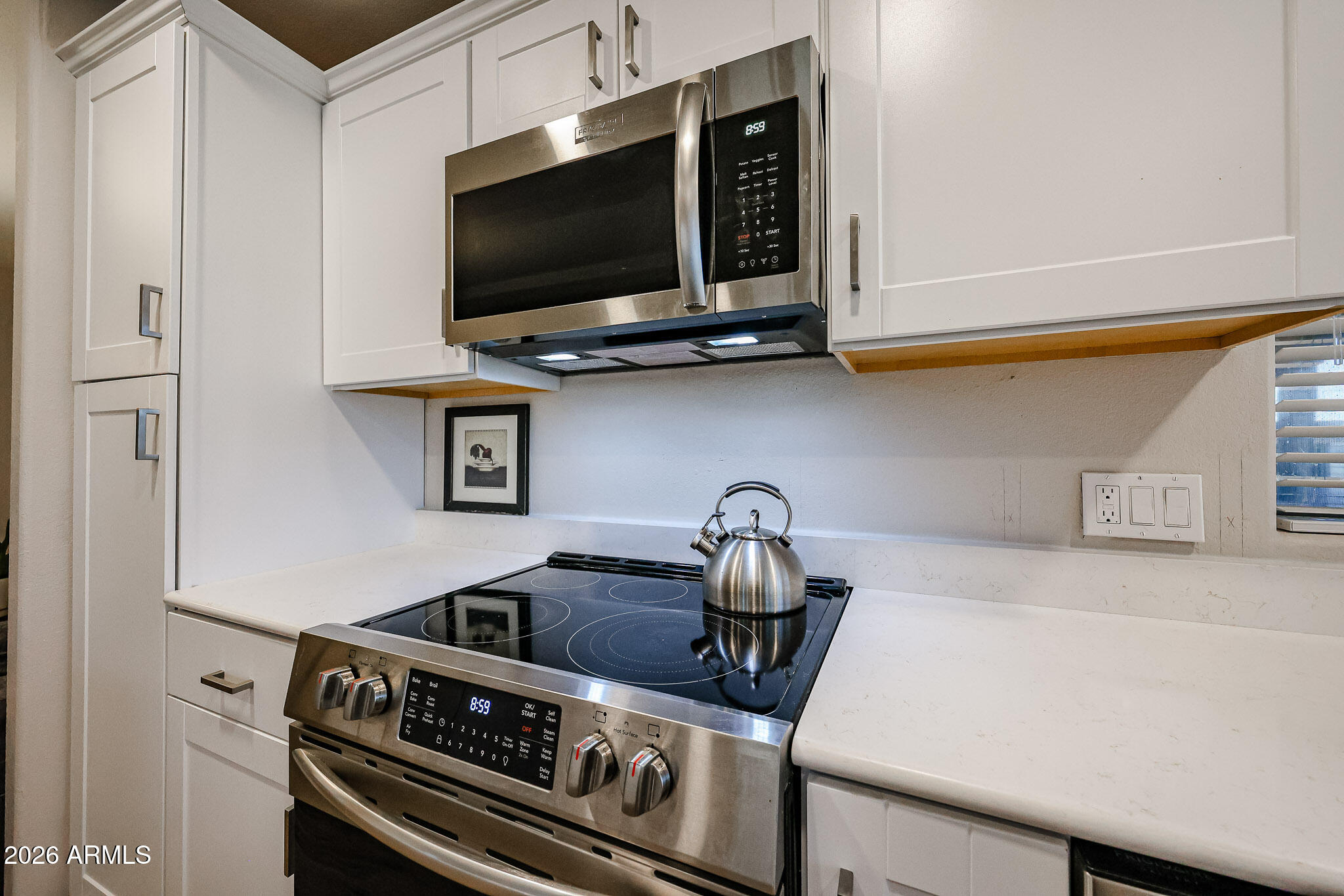 3901 East Pinnacle Peak Road, Unit 109 Phoenix, AZ 85050 - Photo 12 of 31 a kitchen with a stove and a microwave