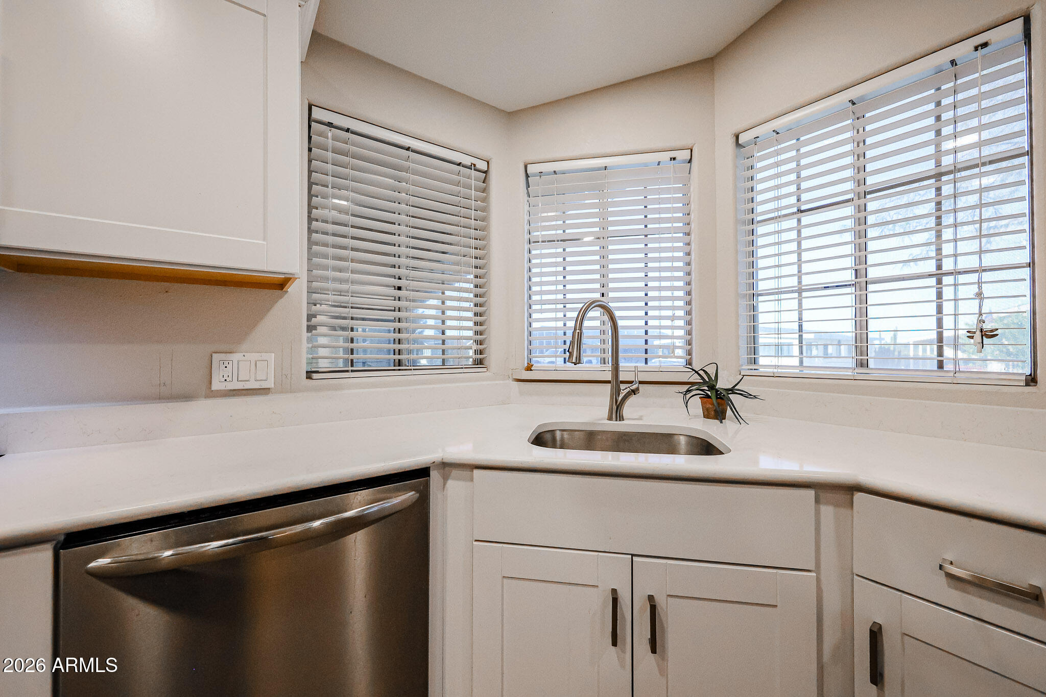3901 East Pinnacle Peak Road, Unit 109 Phoenix, AZ 85050 - Photo 13 of 31 a kitchen with a sink and a window