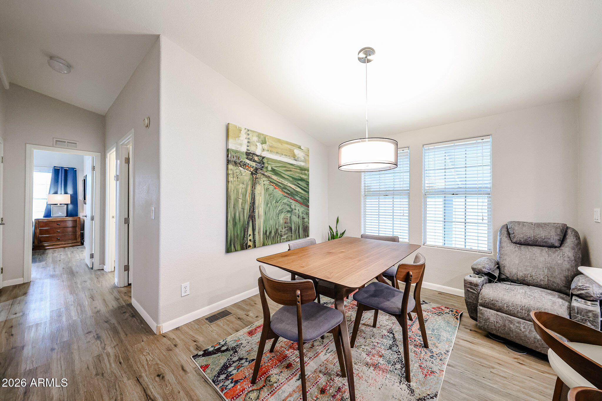 3901 East Pinnacle Peak Road, Unit 109 Phoenix, AZ 85050 - Photo 14 of 31 a view of a dining room with furniture window and wooden floor
