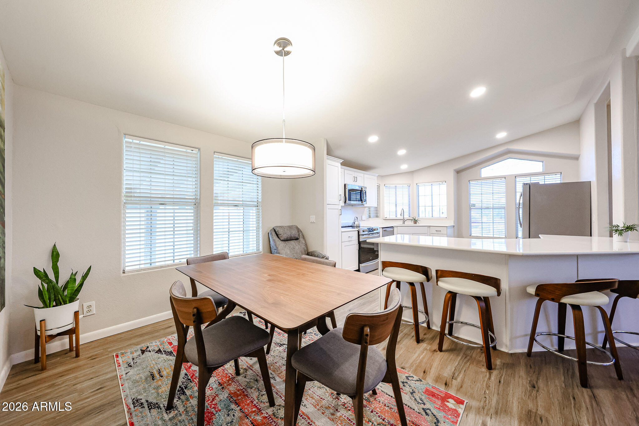 3901 East Pinnacle Peak Road, Unit 109 Phoenix, AZ 85050 - Photo 15 of 31 a kitchen with a table and chairs in it