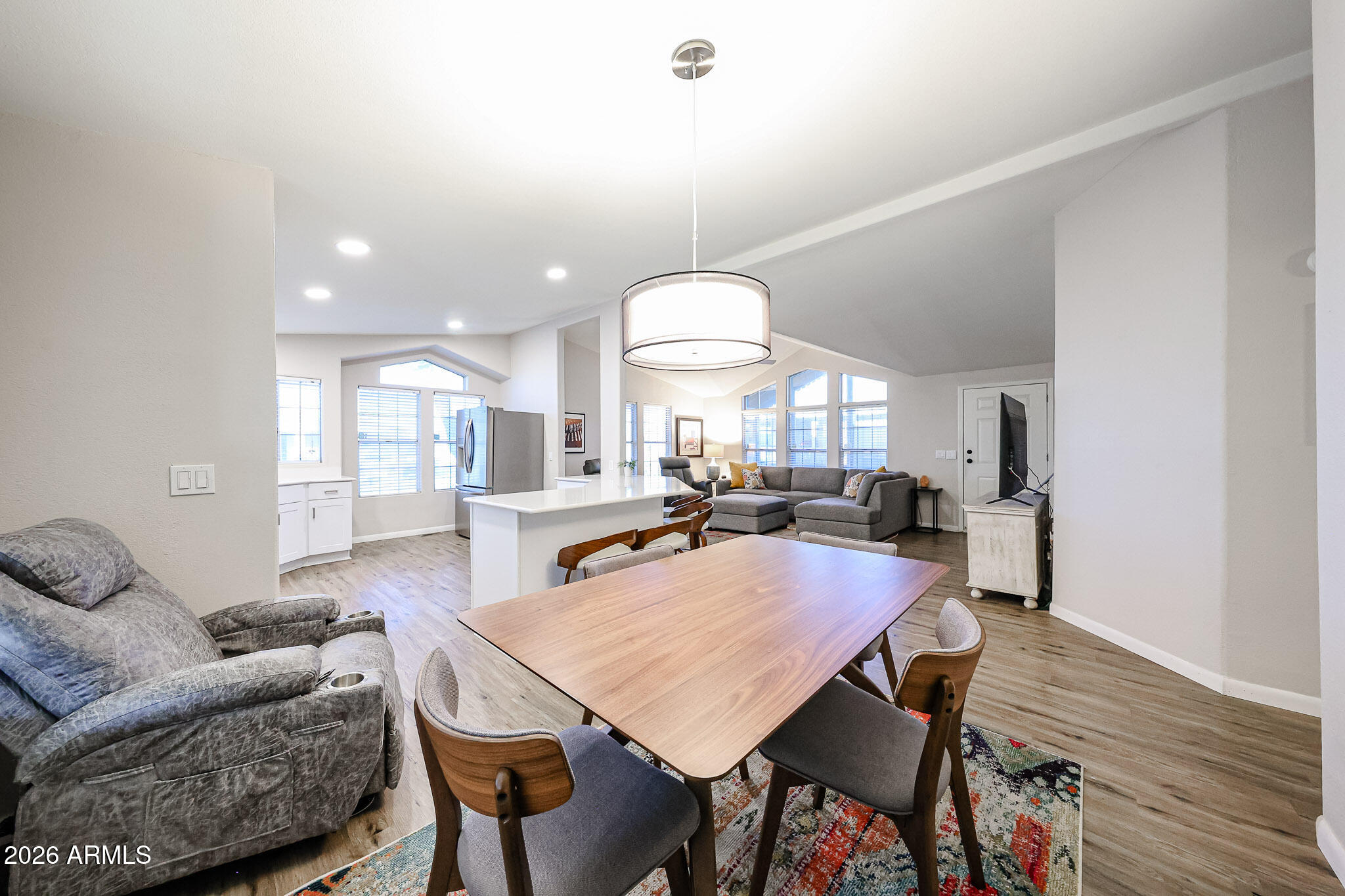 3901 East Pinnacle Peak Road, Unit 109 Phoenix, AZ 85050 - Photo 16 of 31 a view of a dining room with furniture and wooden floor