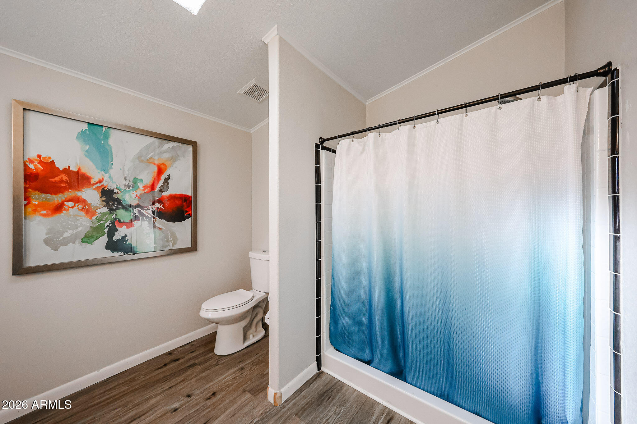 3901 East Pinnacle Peak Road, Unit 109 Phoenix, AZ 85050 - Photo 26 of 31 a view of a bathroom with a painting on the wall and a shower