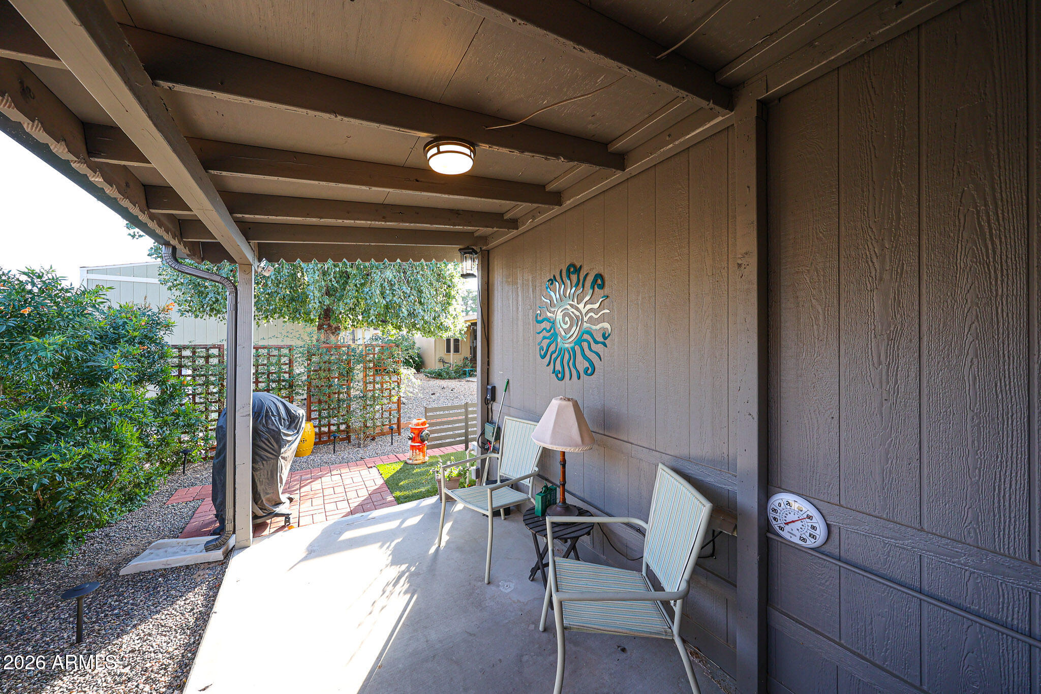 3901 East Pinnacle Peak Road, Unit 109 Phoenix, AZ 85050 - Photo 3 of 31 a view of a porch with furniture and garden