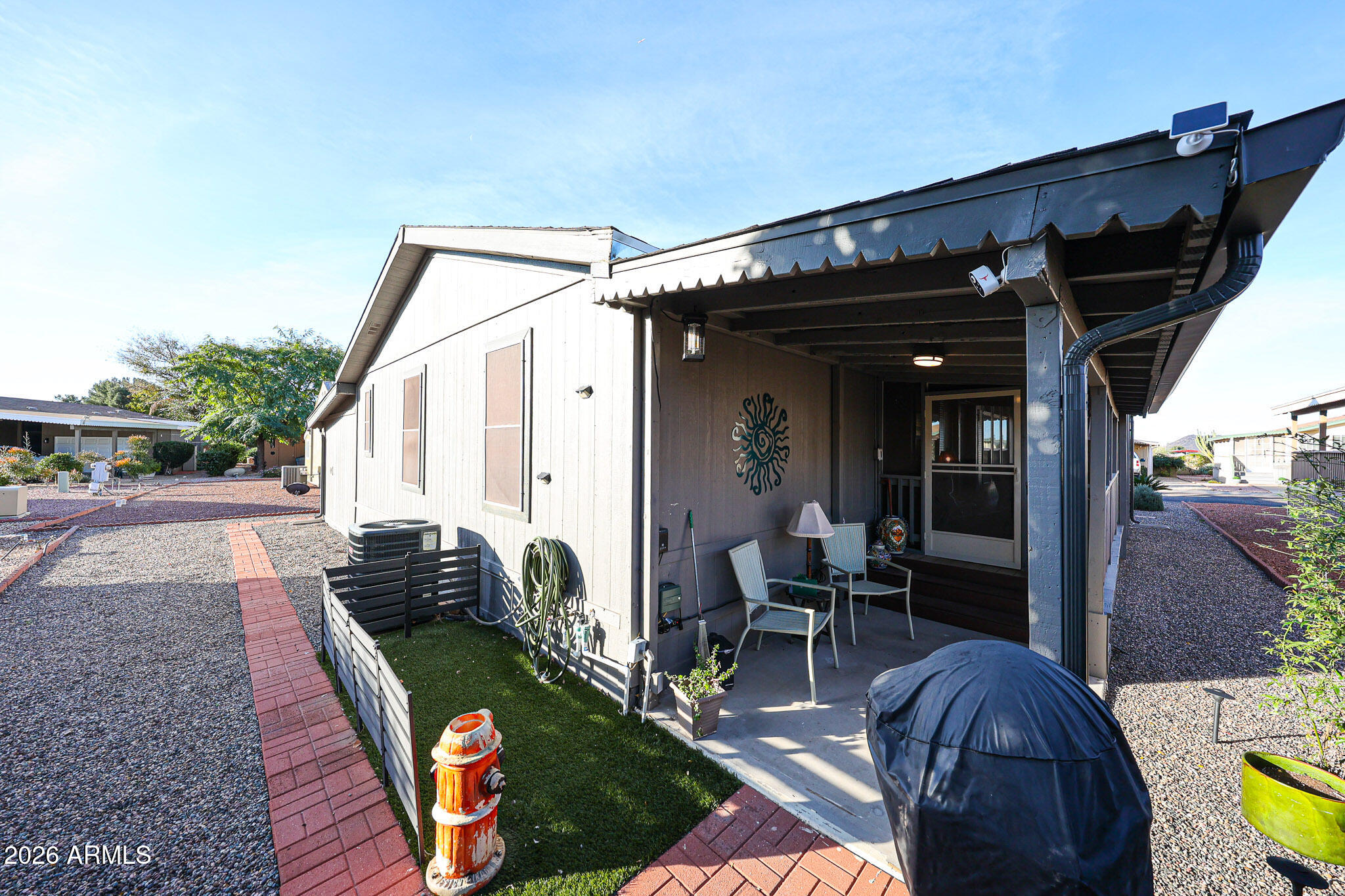 3901 East Pinnacle Peak Road, Unit 109 Phoenix, AZ 85050 - Photo 4 of 31 a view of a porch with furniture and floor to ceiling window