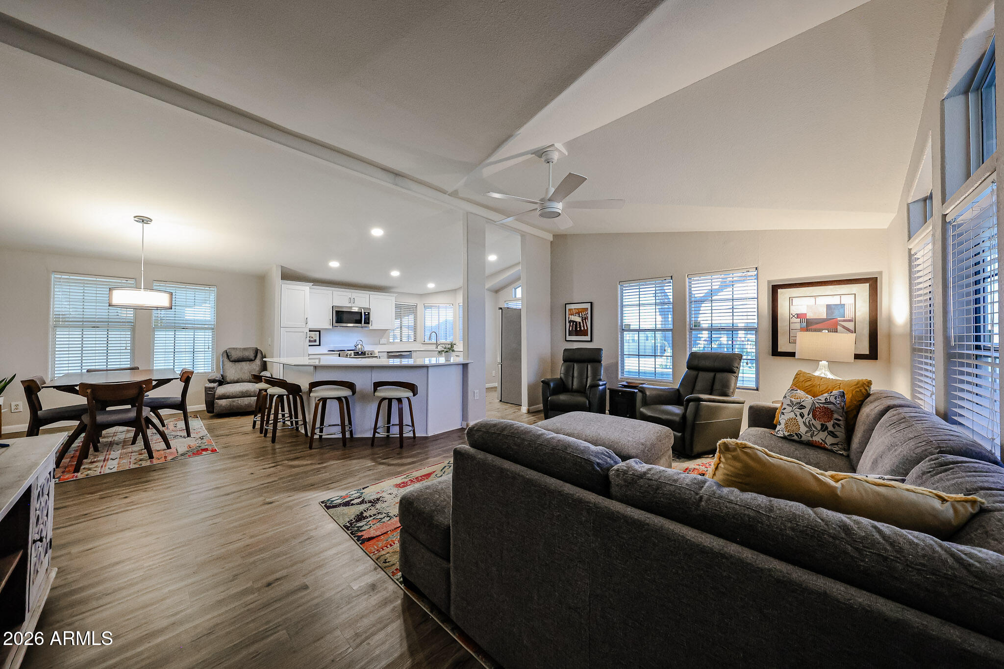 3901 East Pinnacle Peak Road, Unit 109 Phoenix, AZ 85050 - Photo 5 of 31 a living room with furniture a table and kitchen view