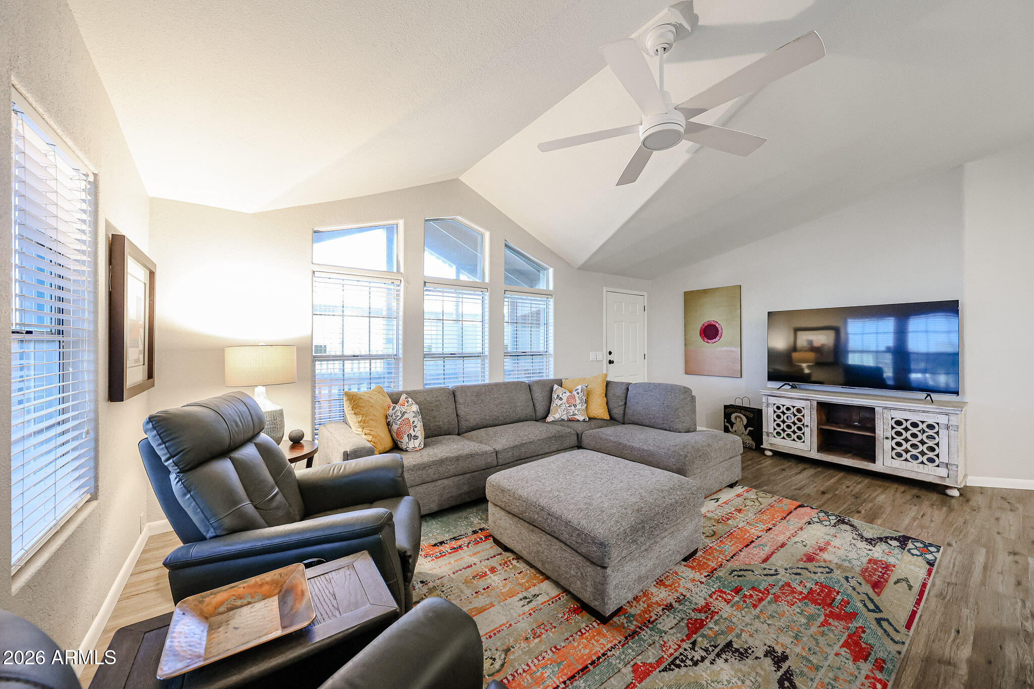3901 East Pinnacle Peak Road, Unit 109 Phoenix, AZ 85050 - Photo 7 of 31 a living room with furniture and a flat screen tv