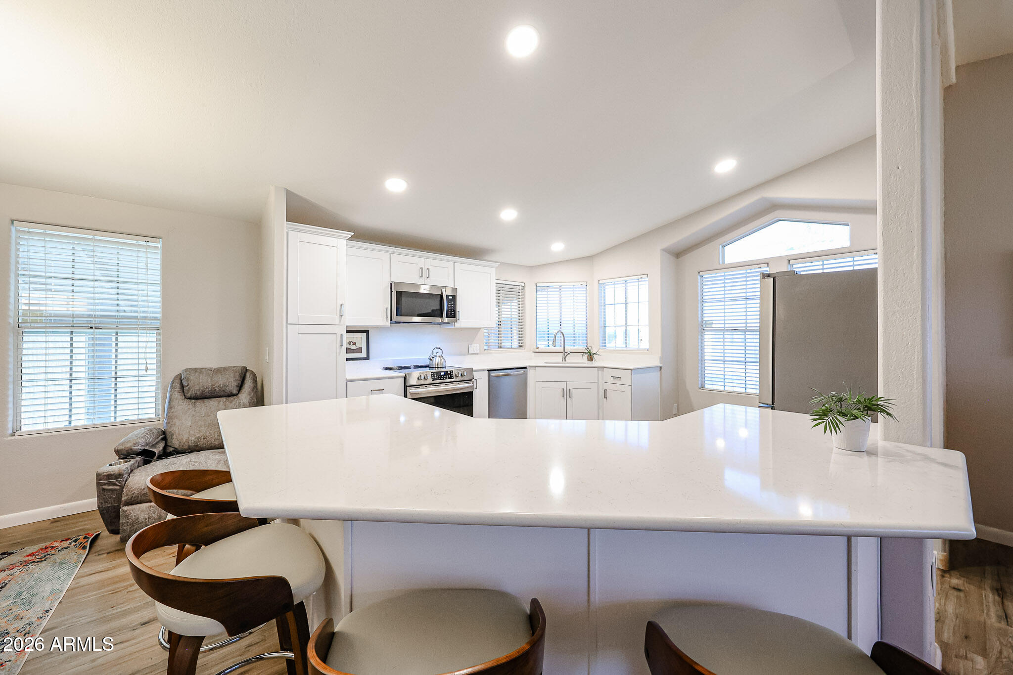 3901 East Pinnacle Peak Road, Unit 109 Phoenix, AZ 85050 - Photo 8 of 31 a large kitchen with a table and chairs