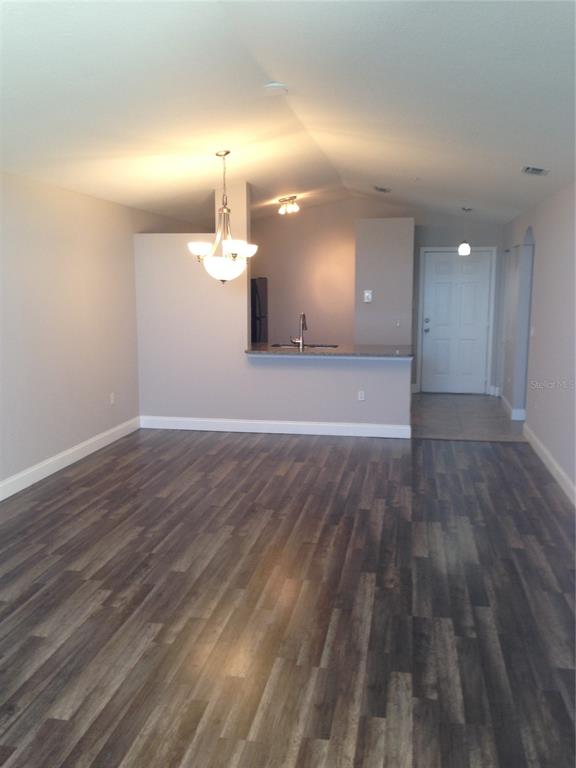 3373 South Kirkman Road, Unit 935 Orlando, FL 32811 - Photo 7 of 20 a view of a room with wooden floor
