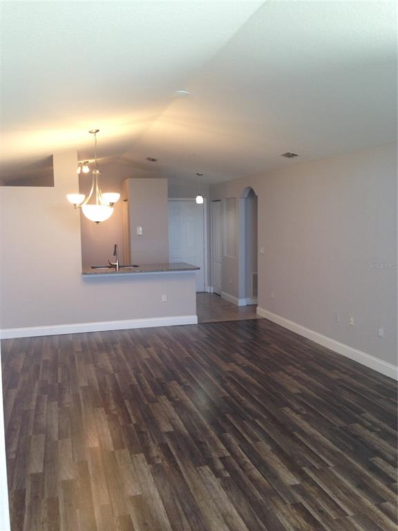 3373 South Kirkman Road, Unit 935 Orlando, FL 32811 - Photo 8 of 20 a view of an empty room with a kitchen