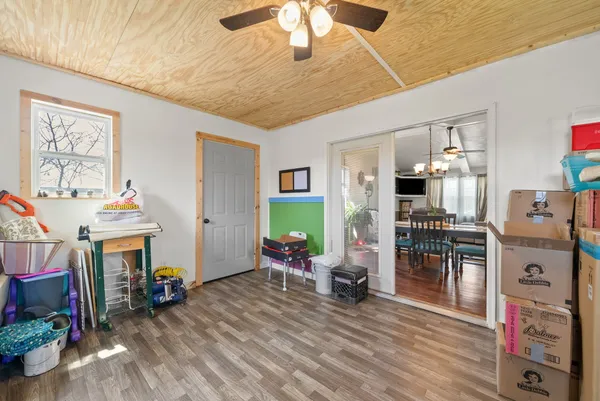 a kitchen with stainless steel appliances wooden floor sink and wooden cabinets