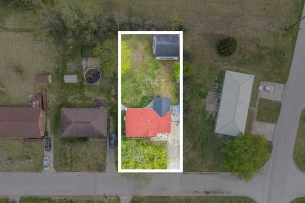 a front view of a house with yard and green space