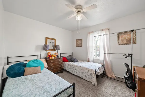 a bedroom with bed and a chandelier