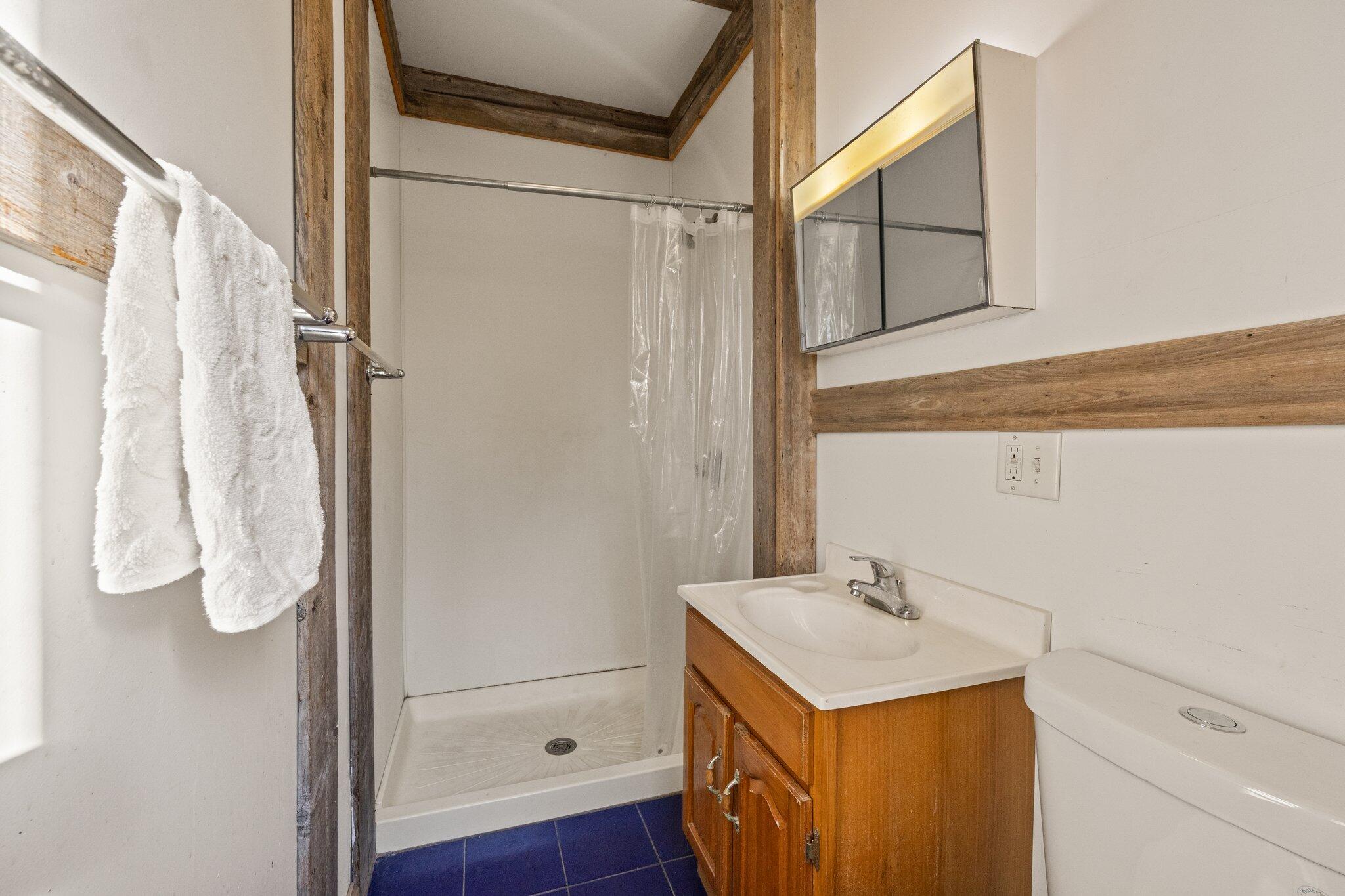 9 Peters Pond Road Truro, MA 02666 - Photo 15 of 35 a bathroom with a sink toilet and shower