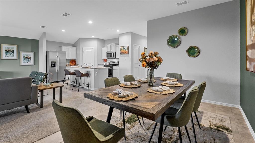 213 EC Tally Drive Justin, TX 76247 - Photo 14 of 40 a dining room with furniture and a potted plant