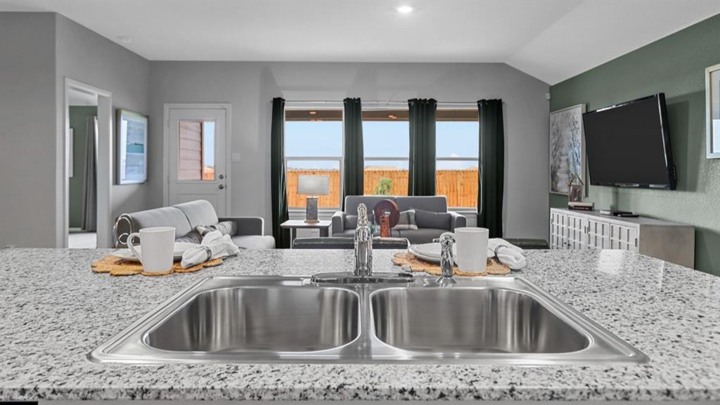 213 EC Tally Drive Justin, TX 76247 - Photo 4 of 40 a kitchen counter top a stove and a sink