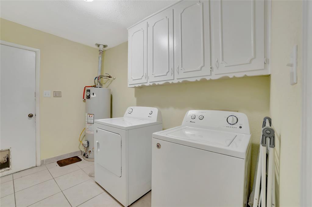 6021 Sycamore Creek Road Edgecliff Village, TX 76134 - Photo 25 of 37 Washroom featuring gas water heater, separate washer and dryer, cabinet space, and light tile patterned floors