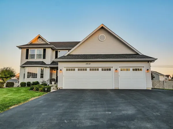 a front view of a house with a yard and garage