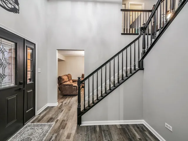 a view of entryway and hall with wooden floor