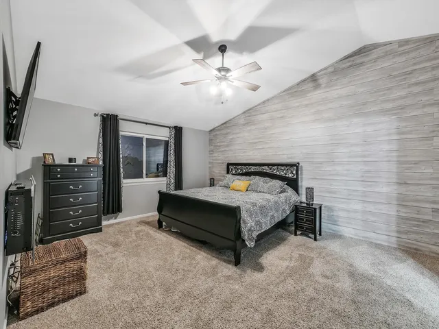 a bed room with a bed and a television