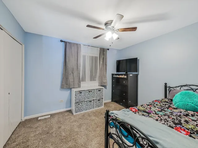 a bedroom with a bed and a tv in it