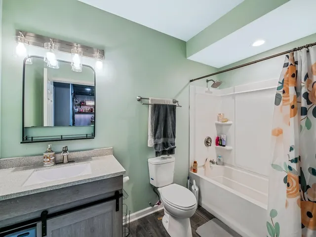 a bathroom with a sink toilet tub and shower