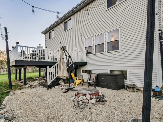 a view of a house with chairs on roof deck