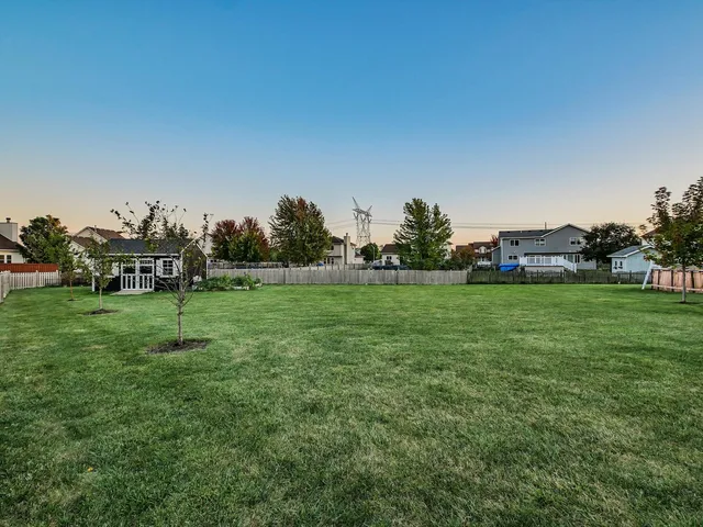a view of grassy field with benches