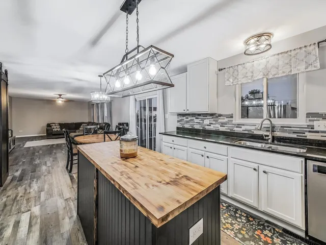 a kitchen with kitchen island granite countertop a sink and stove