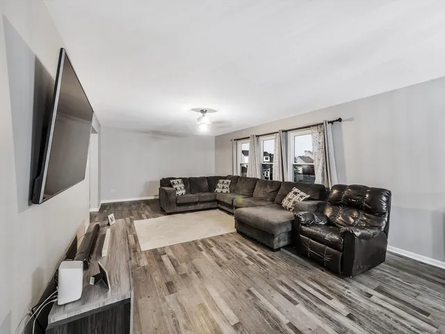 a living room with furniture window and a flat screen tv