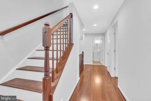 an empty room with wooden floor a ceiling fan and closet