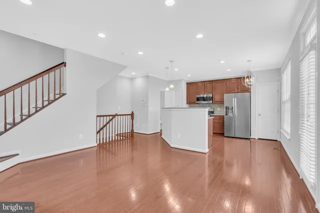 a kitchen with stainless steel appliances granite countertop a stove a refrigerator and a microwave