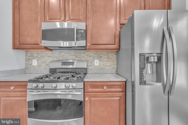 a kitchen with stainless steel appliances granite countertop a sink and a granite counter tops