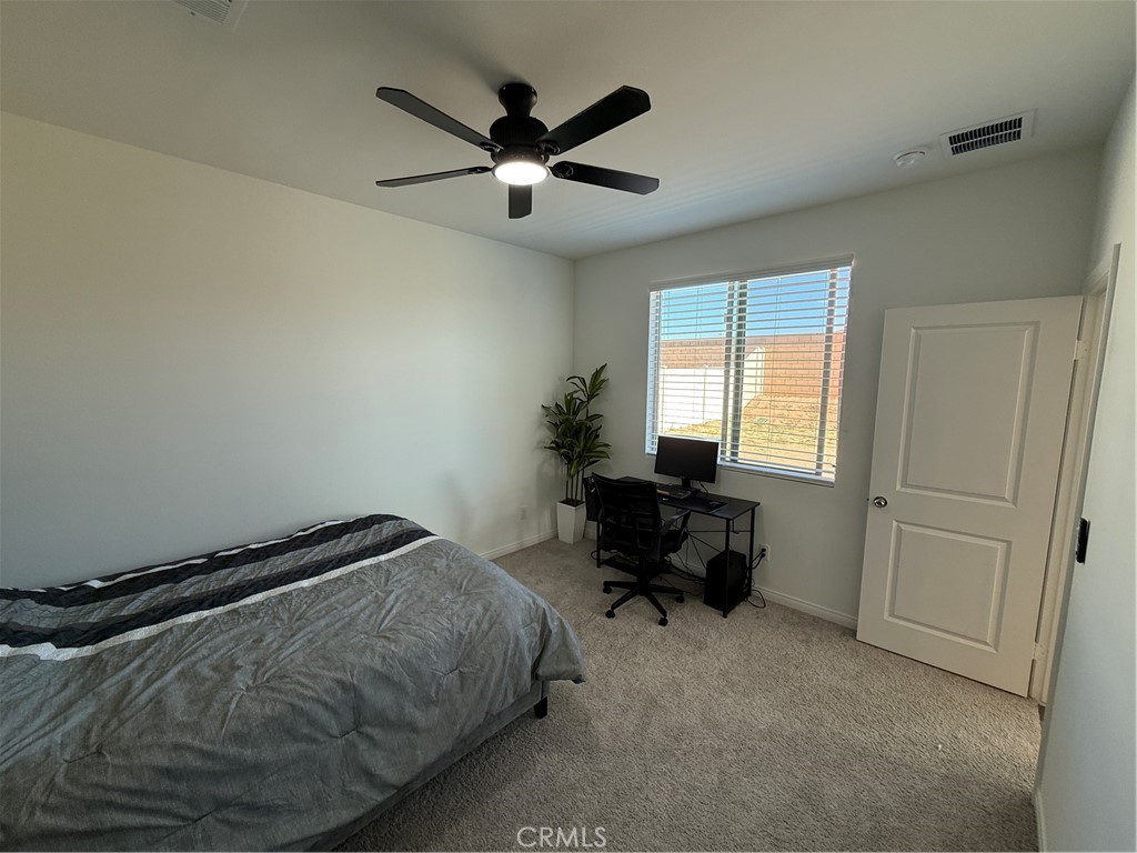 4461 Hickory Court Perris, CA 92571 - Photo 16 of 31 a bedroom with a bed and a window
