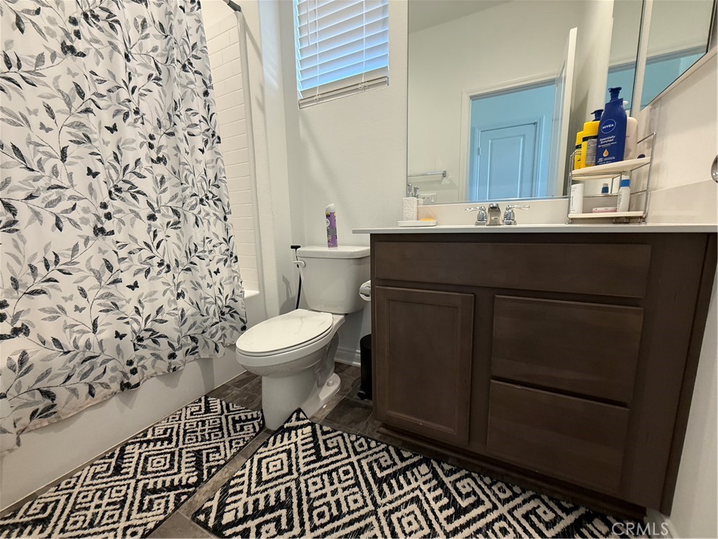 4461 Hickory Court Perris, CA 92571 - Photo 17 of 31 a bathroom with a sink toilet and shower