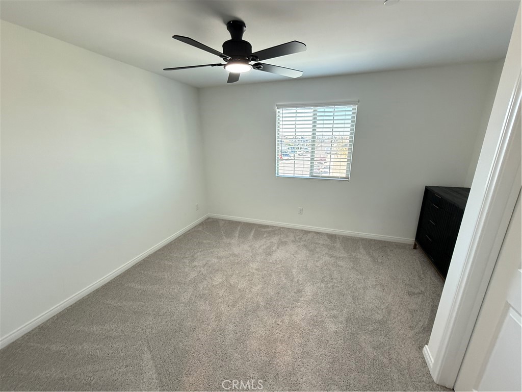 4461 Hickory Court Perris, CA 92571 - Photo 21 of 31 an empty room with a window and a fan