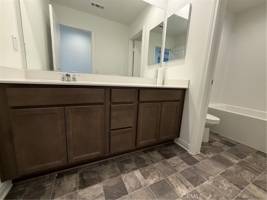 4461 Hickory Court Perris, CA 92571 - Photo 24 of 31 a bathroom with a sink and a mirror