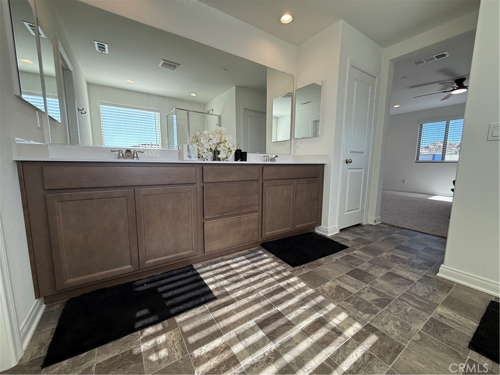4461 Hickory Court Perris, CA 92571 - Photo 30 of 31 a bathroom with a sink a mirror and a toilet