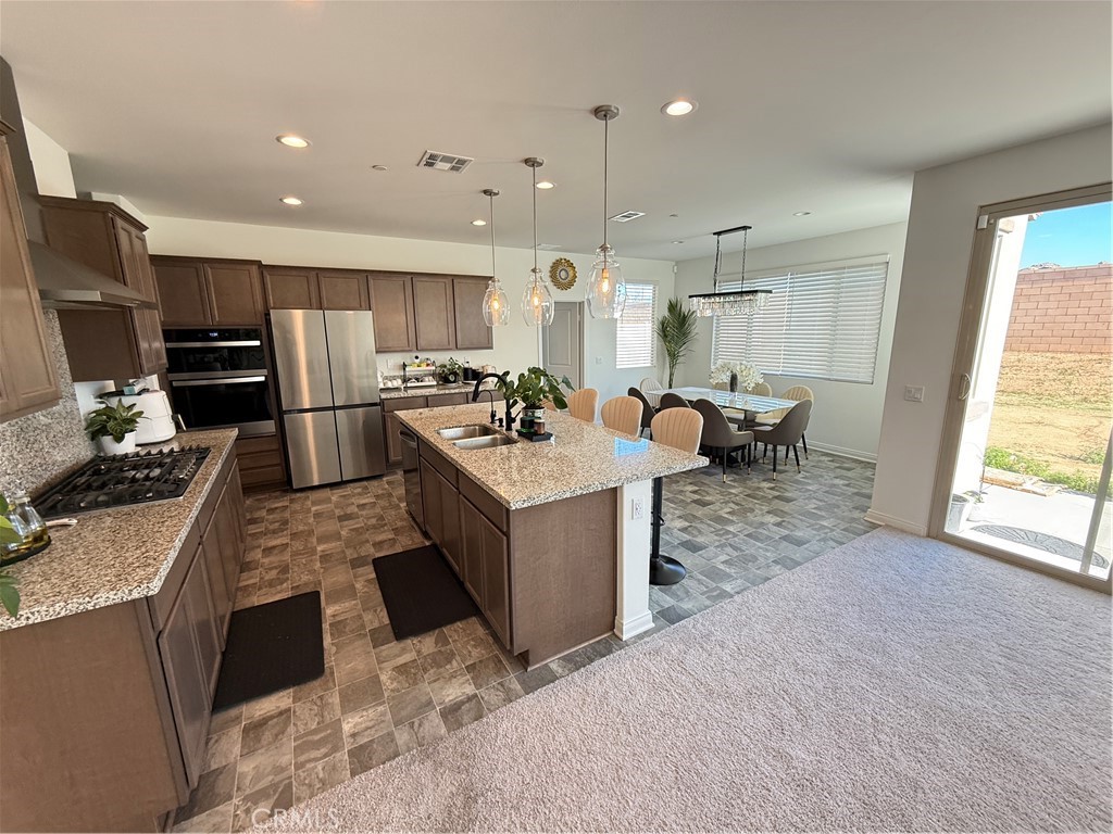 4461 Hickory Court Perris, CA 92571 - Photo 8 of 31 a large white kitchen with sink stove and refrigerator